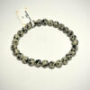 Bracelet en 6 mm en Jaspe dalmatien posé sur fond blanc