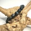 Bracelet Oeil de faucon en 8 mm posé sur morceau de bois