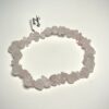 Bracelet bohème en pépite de pierre de quartz rose posé sur fond blanc